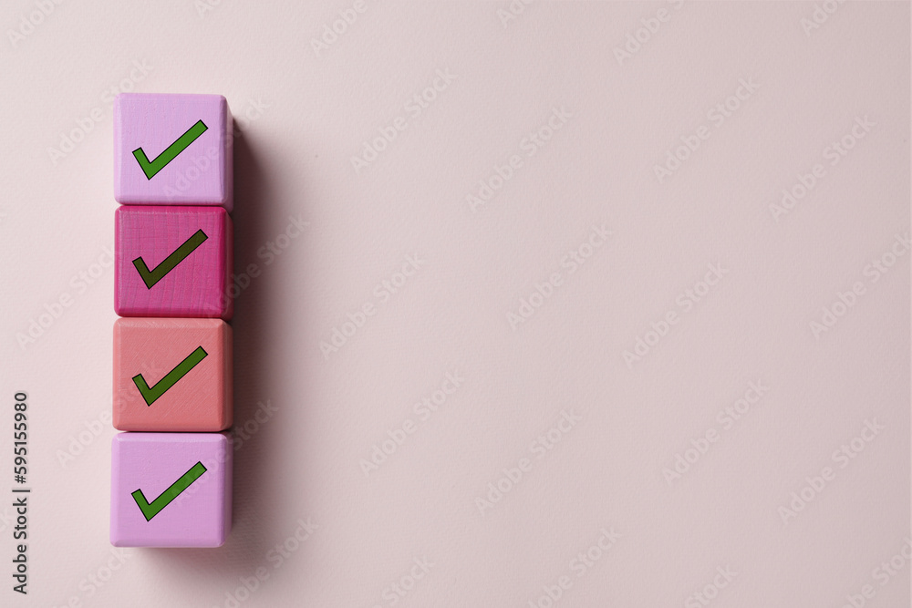 Cubes with check marks on beige background, top view. Space for text Cubes with check marks on beige background, top view. Space for text