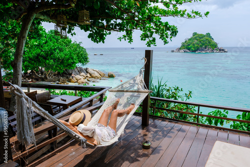 Asia women on vacation at Koh Lipe Island Thailand relaxing at a hammock photo