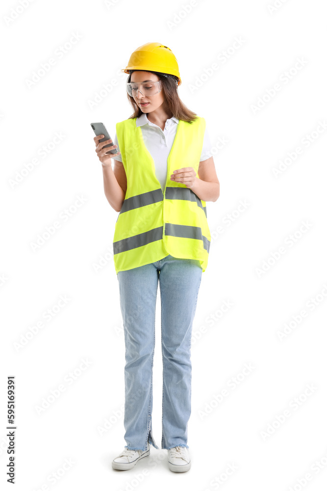 Female worker in vest and hardhat holding mobile phone on white background Female worker in vest and hardhat holding mobile phone on white background