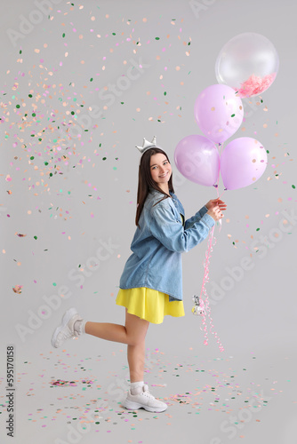 Happy young woman with ball...