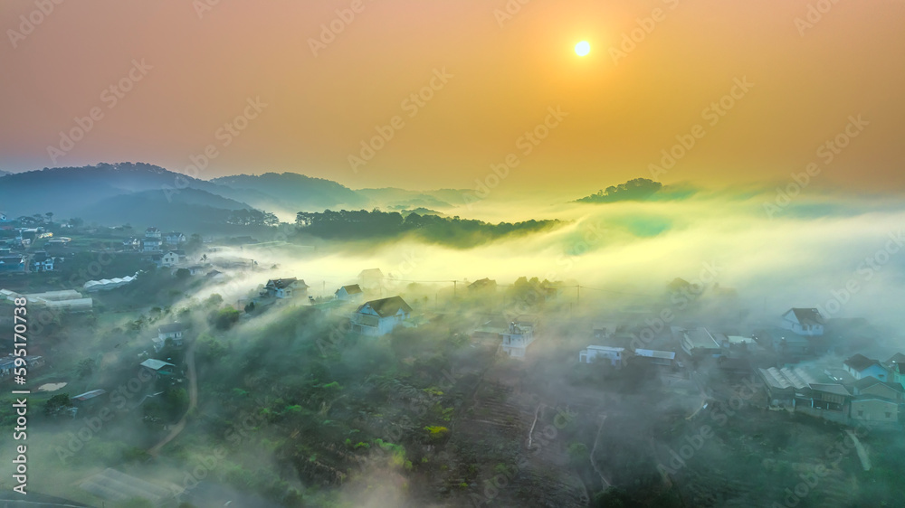 Aerial view of Xuan Tho suburbs near Da Lat city at morning with misty and sunrise sky. This place is considered most beautiful and peaceful place to watch sunrise in highlands of Vietnam