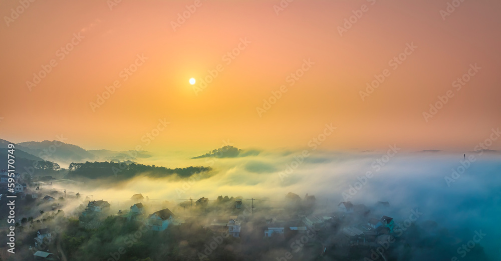 Obraz premium Aerial view of Xuan Tho suburbs near Da Lat city at morning with misty and sunrise sky. This place is considered most beautiful and peaceful place to watch sunrise in highlands of Vietnam