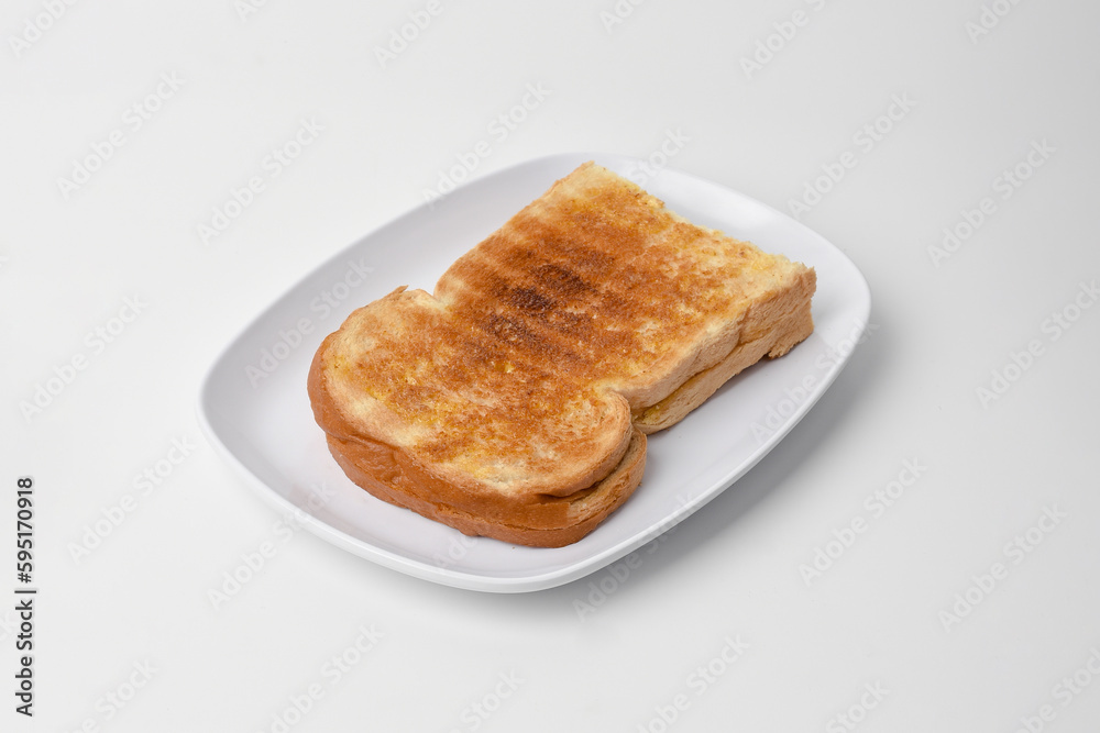 toasted bread on a white plate isolated on a white background. toasted bread on a white plate isolated on a white background.