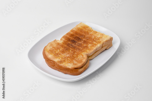 toasted bread on a white plate isolated on a white background.
