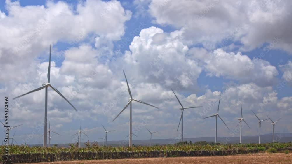 A wind farm with powerful wind turbines to generate electricity. The concept of green energy. A wind farm with powerful wind turbines to generate electricity. The concept of green energy.