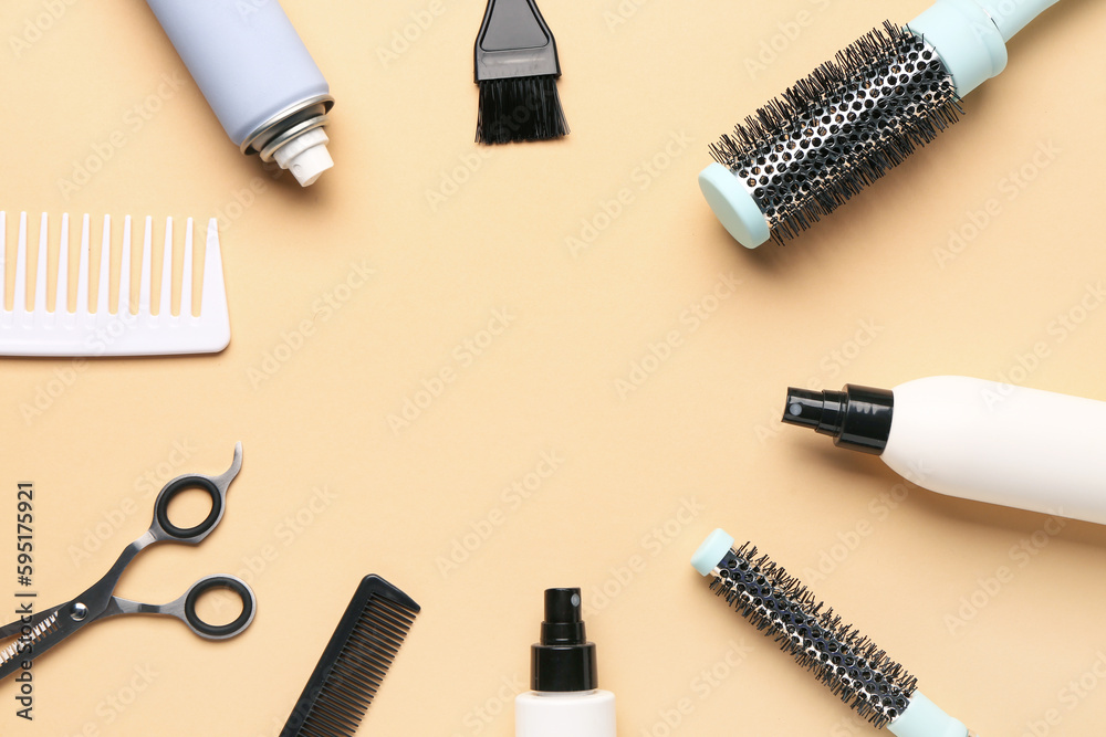 Frame made of hairdressing accessories on beige background Frame made of hairdressing accessories on beige background