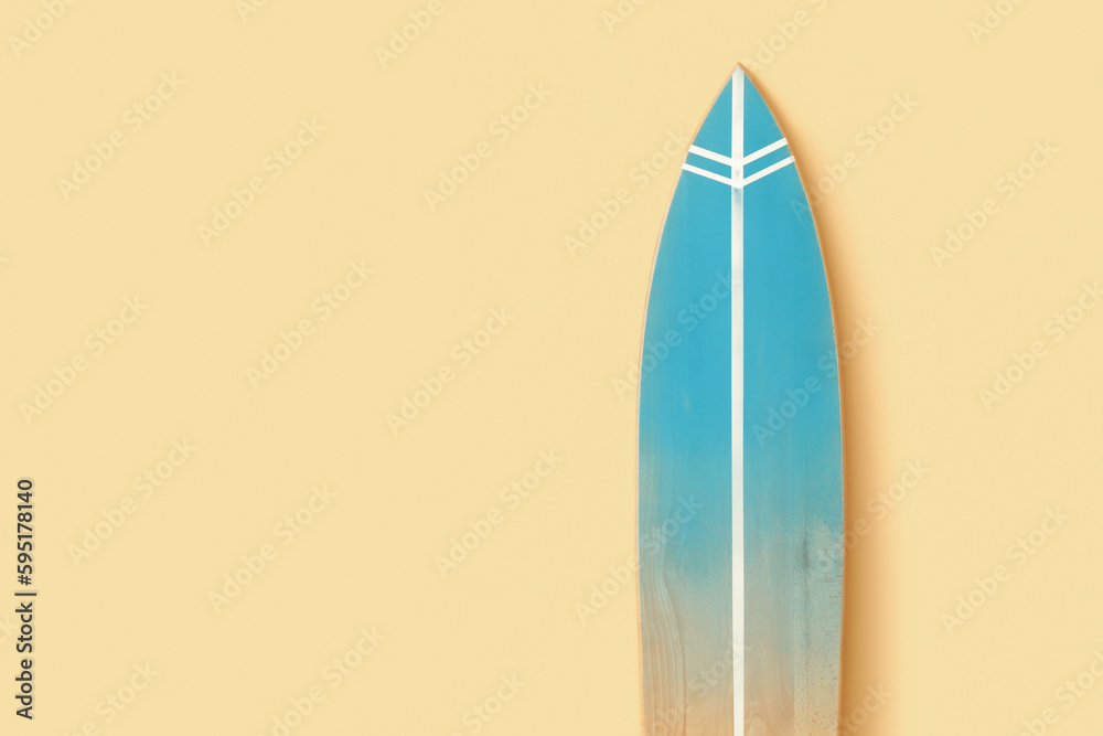 Wooden surfboard near beige wall, closeup Wooden surfboard near beige wall, closeup