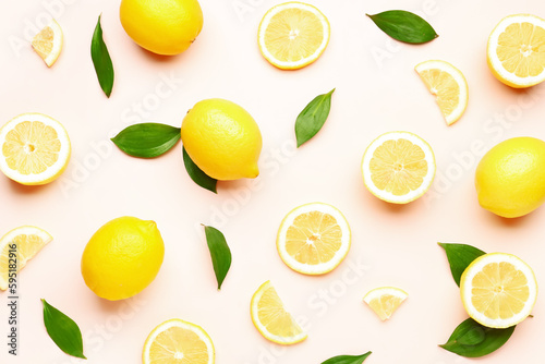 Composition with fresh lemons on pink background