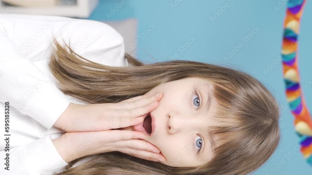 Vertical Video of The little girl is surprised. Vertical Video of The little girl is surprised.