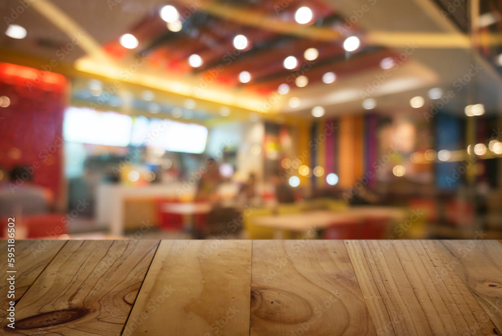 Empty wooden table in front of abstract blurred background of coffee shop . can be used for display Mock up  of product