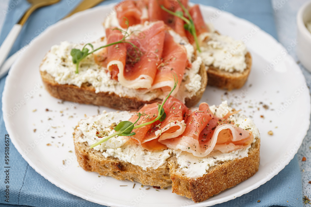 Plate of tasty bruschettas with jamon on light background Plate of tasty bruschettas with jamon on light background
