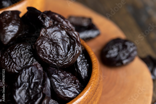 Black pile of prunes from a large number of ripe plums
