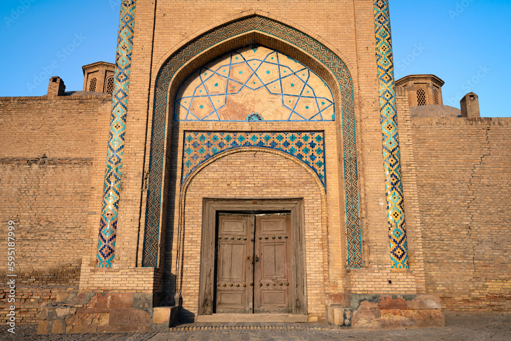 Entrance of the ancient madrasah of Emir Alimkhan close-up on a sunny evening. Bukhara. Uzbekistan
