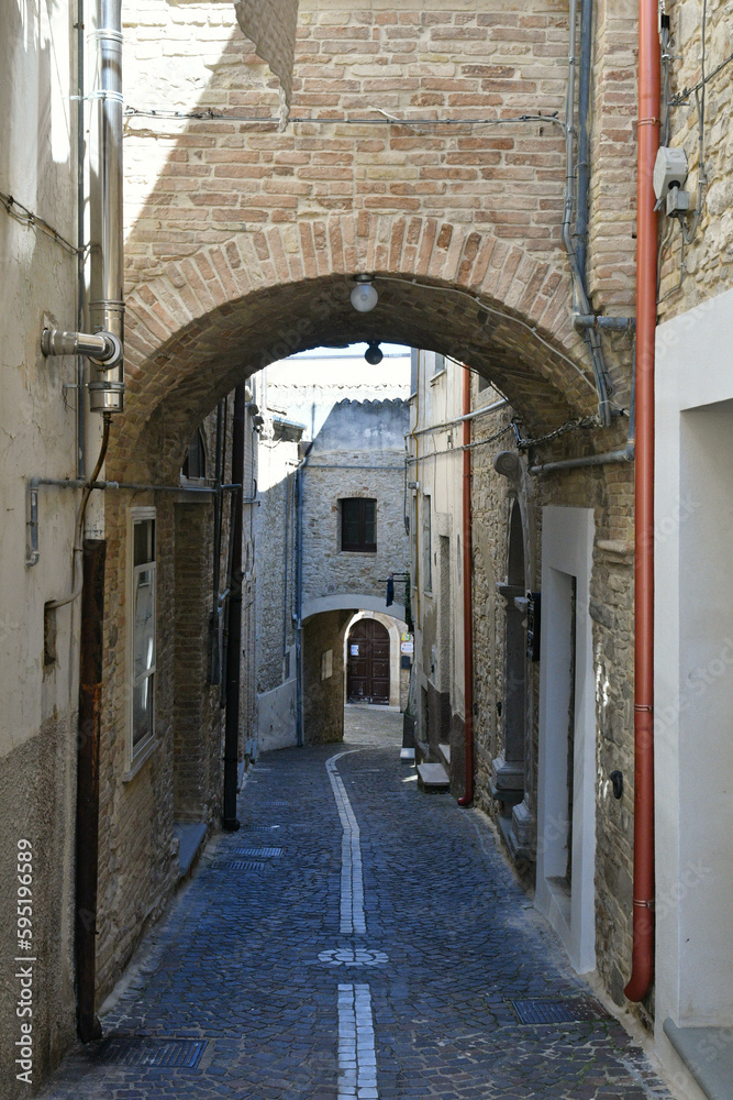 A narrow street among the old houses of Biccari, a historic town in the state of Puglia in Italy.