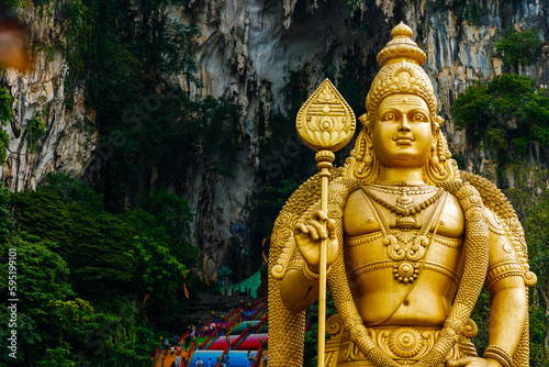 The Batu Caves Lord Murugan Statue and entrance near Kuala Lumpur Malaysia. A limestone outcrop located just north of Kuala Lumpur, Batu Caves has three main caves featuring temples and Hindu shrines.