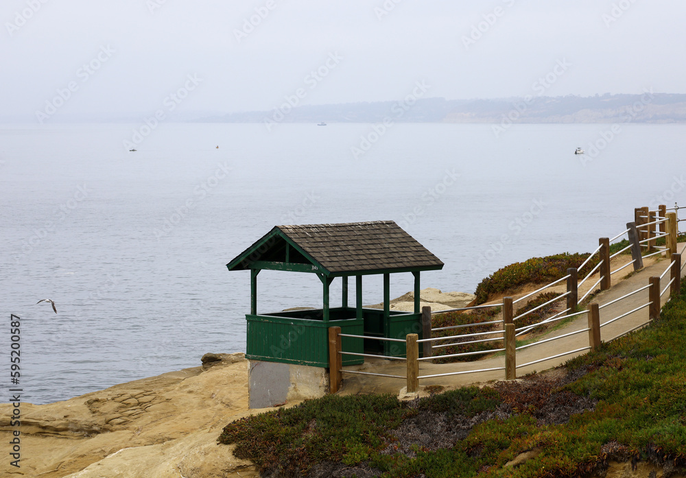 One of the historic green huts between Shell Beach and Boomer Beach in La Jolla, California. Resting and scenic area.