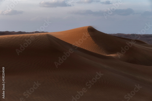 Sunset over sand dunes of Oman