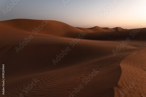 Sunset over sand dunes of Oman