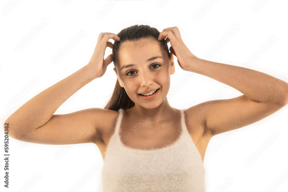 Lovely girl touching her hair in white wooly top isolated on white background. No makeup. Clean face. Beauty concept Lovely girl touching her hair in white wooly top isolated on white background. No makeup. Clean face. Beauty concept