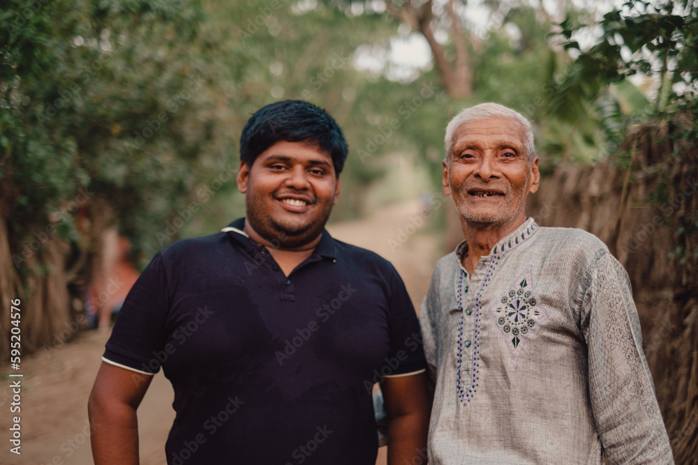 South asian elderly grandfather smiling with his overweight grandson, family happiness concept, togetherness concept, fresh air environment  - obrazy, fototapety, plakaty 