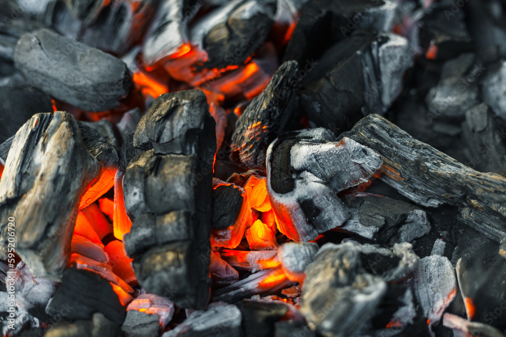 Burning charcoal for grilling close-up. Smoldering charcoal inside the grill gives heat for cooking pickled meat, barbecue, steak, vegetables, barbecue. Burning charcoal for grilling close-up. Smoldering charcoal inside the grill gives heat for cooking pickled meat, barbecue, steak, vegetables, barbecue.