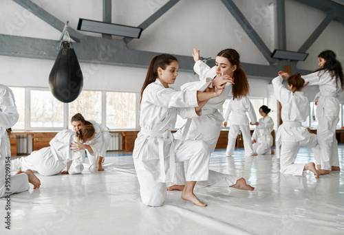 Принти на полотні Teenage girls fighting at aikido training in martial arts school