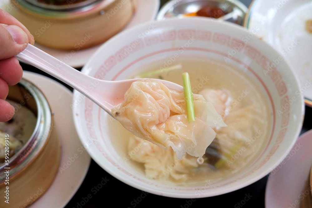 Close up of dumpling in spoon,wonton soup, Chinese dumpling in clear soup Close up of dumpling in spoon,wonton soup, Chinese dumpling in clear soup