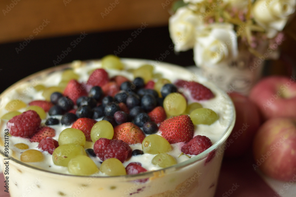 Fresh Fruit on top of Cream Cake with blurry background and shallow depth of field Fresh Fruit on top of Cream Cake with blurry background and shallow depth of field