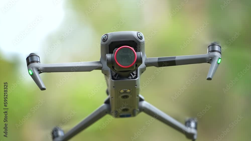 Drone with digital camera and fast rotating propellers flying taking video and pictures Drone with digital camera and fast rotating propellers flying taking video and pictures