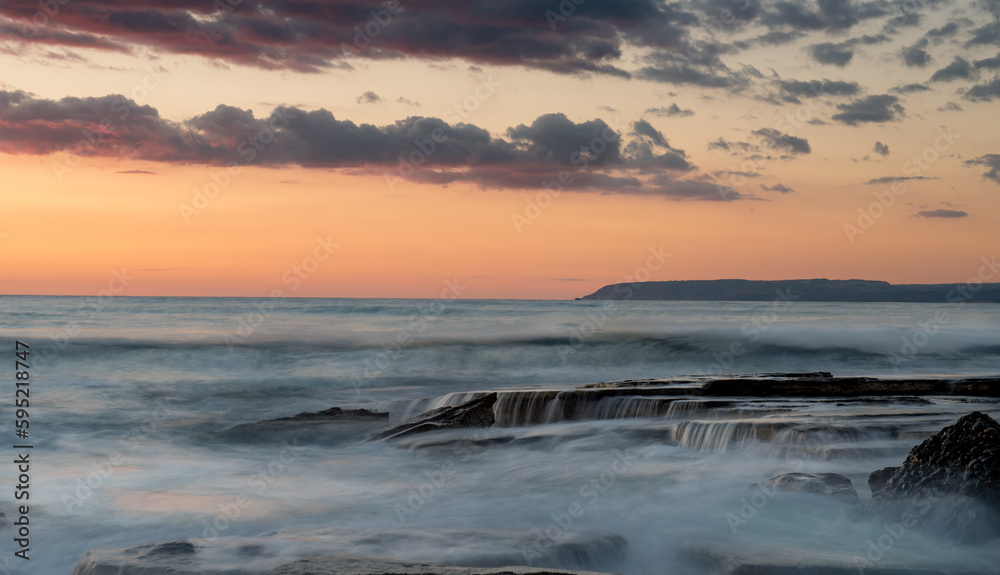Dramatic beautiful sunset on a rocky coast at Akrotiri area in Limassol, Cyprus. Long exposure photography Dramatic beautiful sunset on a rocky coast at Akrotiri area in Limassol, Cyprus. Long exposure photography