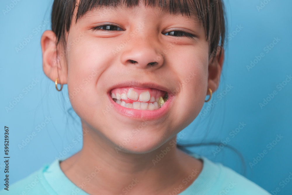Smiling cute little girl eating sweet gelatin with sugar added isolated