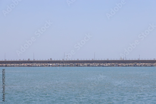 View of the pier in the port of Alanya, minimalism, the Mediterranean Sea. Sunny day. Türkiye, April 2023. © Aleksandr