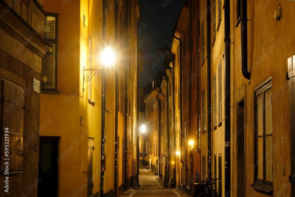 Beautiful scenery of illuminated Stockholm by night. Narrow street on Gamla Stan. Sweden