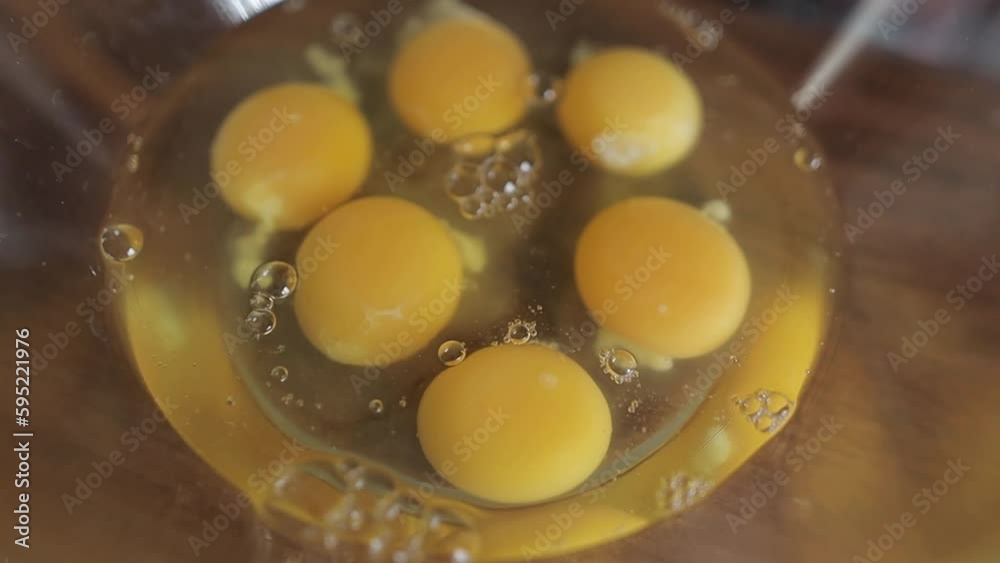 six raw eggs in a glass bowl on the table. Six 6 eggs in a glass bowl on a kitchen wooden table. Lots of fresh eggs in a bowl. six raw eggs in a glass bowl on the table. Six 6 eggs in a glass bowl on a kitchen wooden table. Lots of fresh eggs in a bowl.