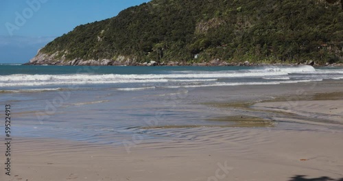 Matadeiro beach with mountains and ocean with waves in Florianopolis. photo