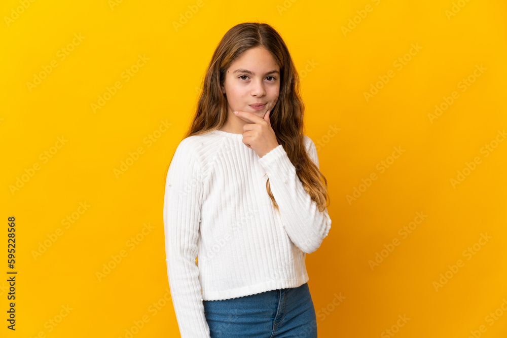 Child over isolated yellow background thinking Child over isolated yellow background thinking
