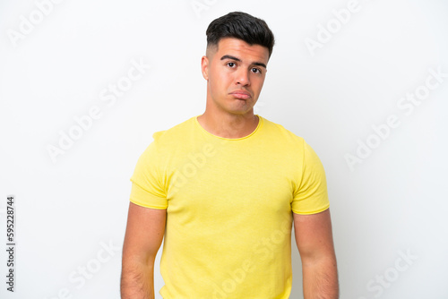 Young caucasian handsome man isolated on white background with sad expression