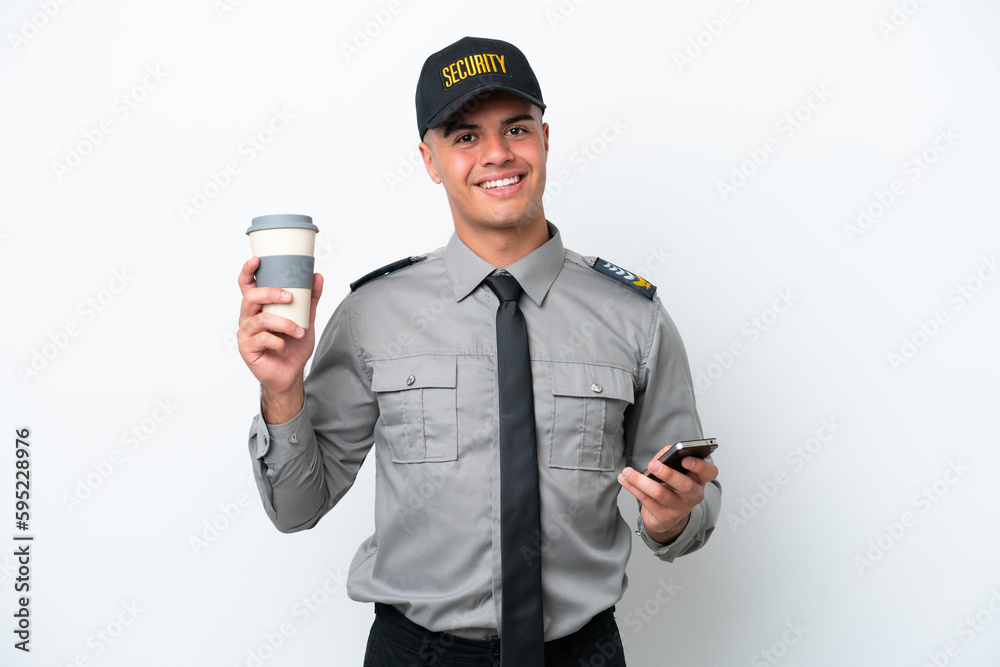 Young caucasian security man isolated on white background holding coffee to take away and a mobile Young caucasian security man isolated on white background holding coffee to take away and a mobile