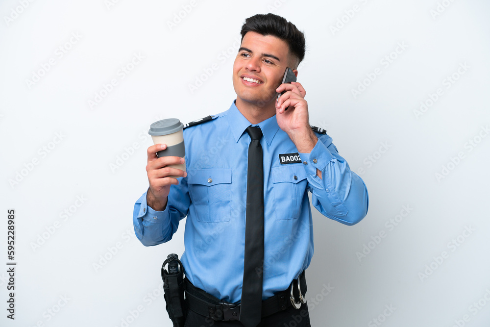 Young police caucasian man isolated on white background holding coffee to take away and a mobile Young police caucasian man isolated on white background holding coffee to take away and a mobile