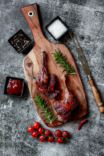 grilled duck legs on a stone background