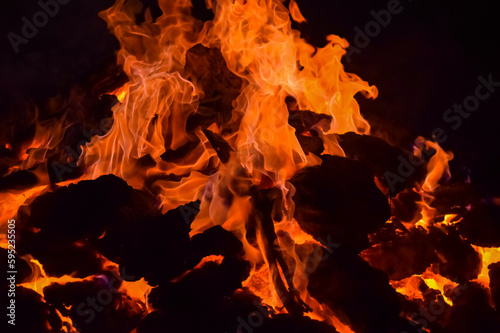 Fire flames on black background, Blaze fire flame texture background, Beautifully, the fire is burning, Fire flames with wood and cow dung bonfire