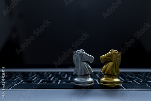 Silver and Gold chess on laptop, Marketing or business strategy, Chess battle victory success, Team leader teamwork business strategy, Chess business concept, Leader and success concept.