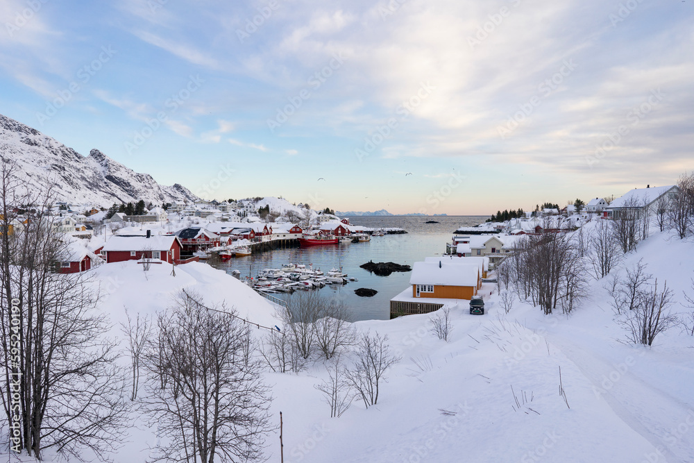 fishing village in the snowy mountains of norway in winter