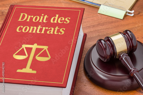 A law book with a gavel - Contract law in french - Droit des contrats