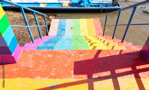 Way down go to canal by stairs colorful rainbow or freshwater lake in one of tourist attractions in Thailand. Rainbow is symbol LGBTQ is term to refer to people of different gender is diverse group. photo