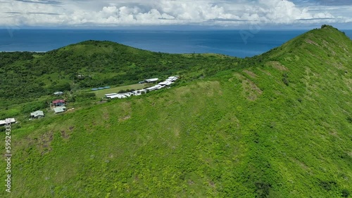 Aerial video of drone flying forward and down over tropical mountain