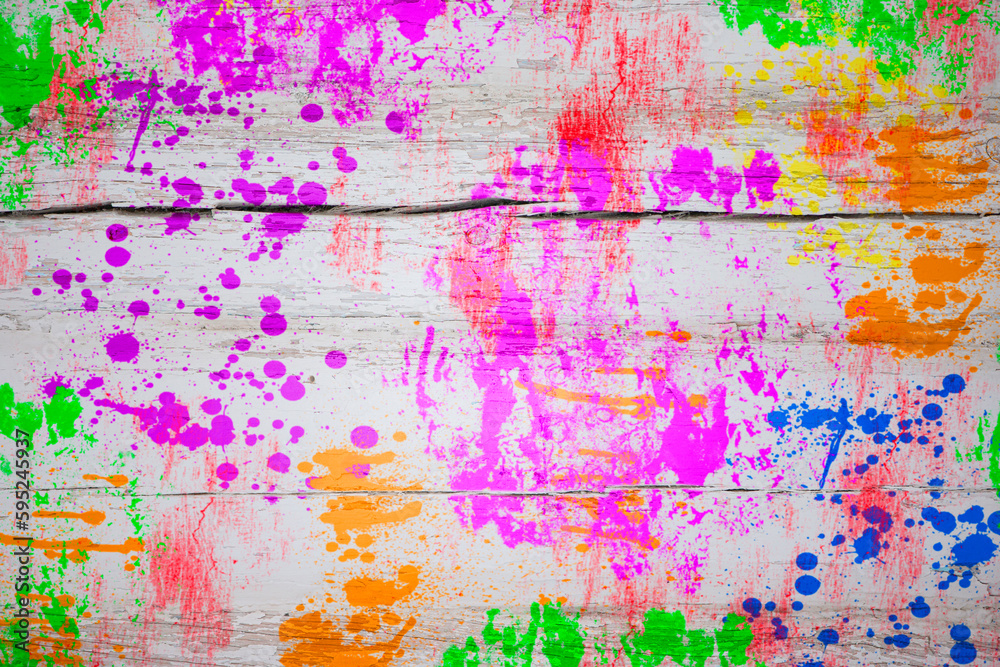 Multicolored paint stains on a wooden board. Bright colorful background.