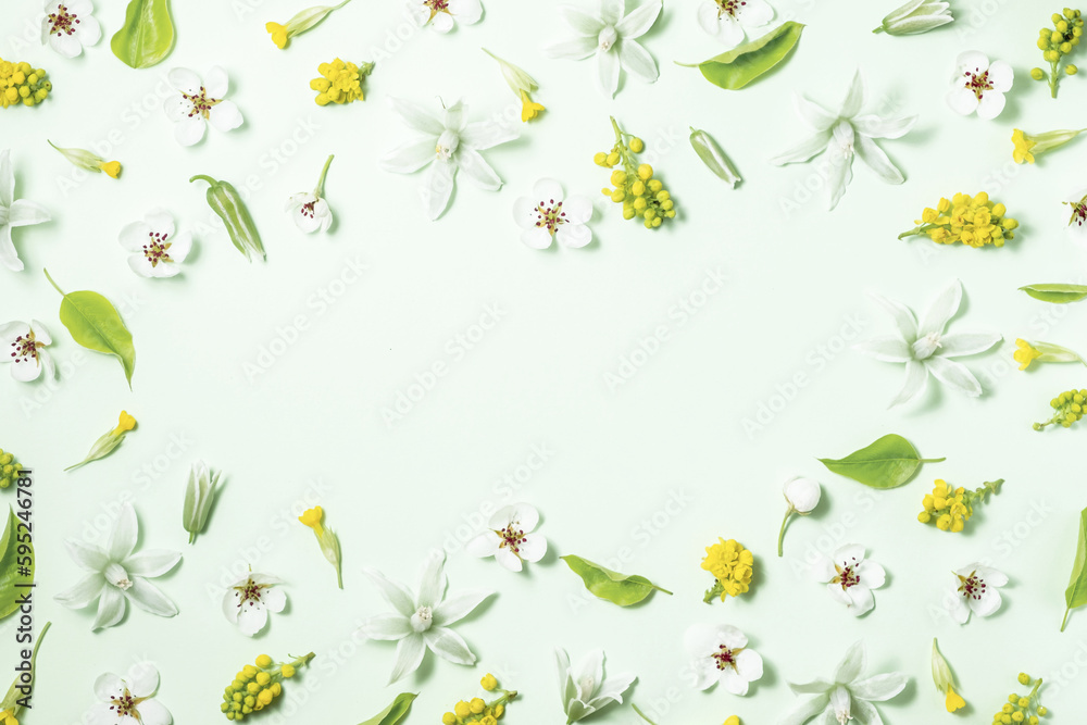 Fototapeta premium Floral frame from spring flowers on a white background. Flat lay, top view, copy space. Beautiful floral composition