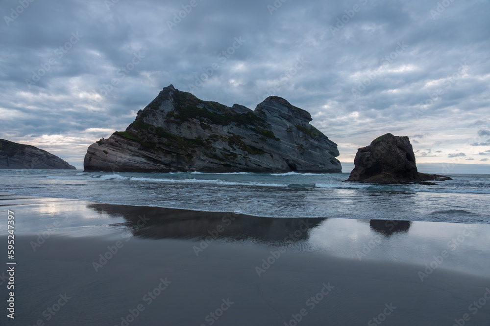 Wharariki Beach and the Archway Islands on the Tasman Sea, west of Cape Farewell, the northernmost point of the South Island of New Zealand.
