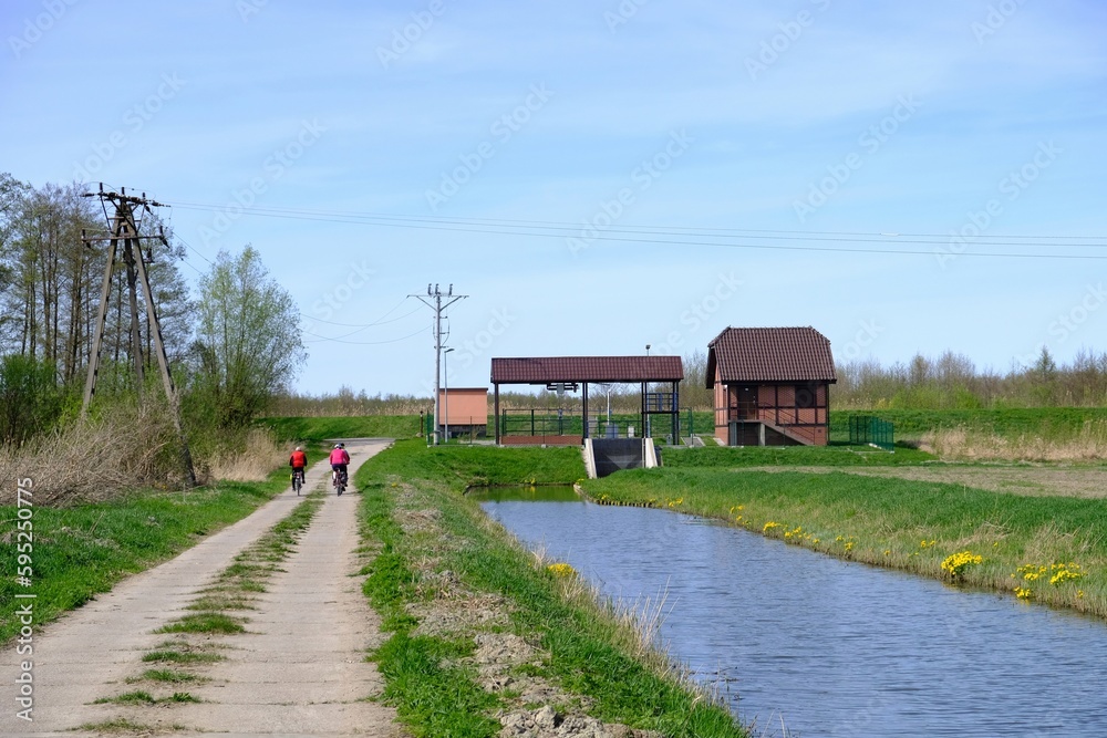 People on bicycle during trip on Zulawy Elblaskie, Warmia and Masuria, Poland People on bicycle during trip on Zulawy Elblaskie, Warmia and Masuria, Poland